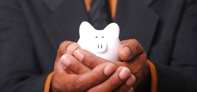 Man holding a white piggy bank.