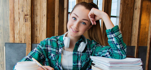 Young girl, student, studying and doing work.