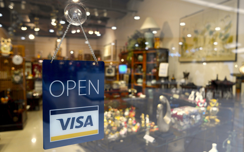 Retail store with OPEN/VISA sign in window.